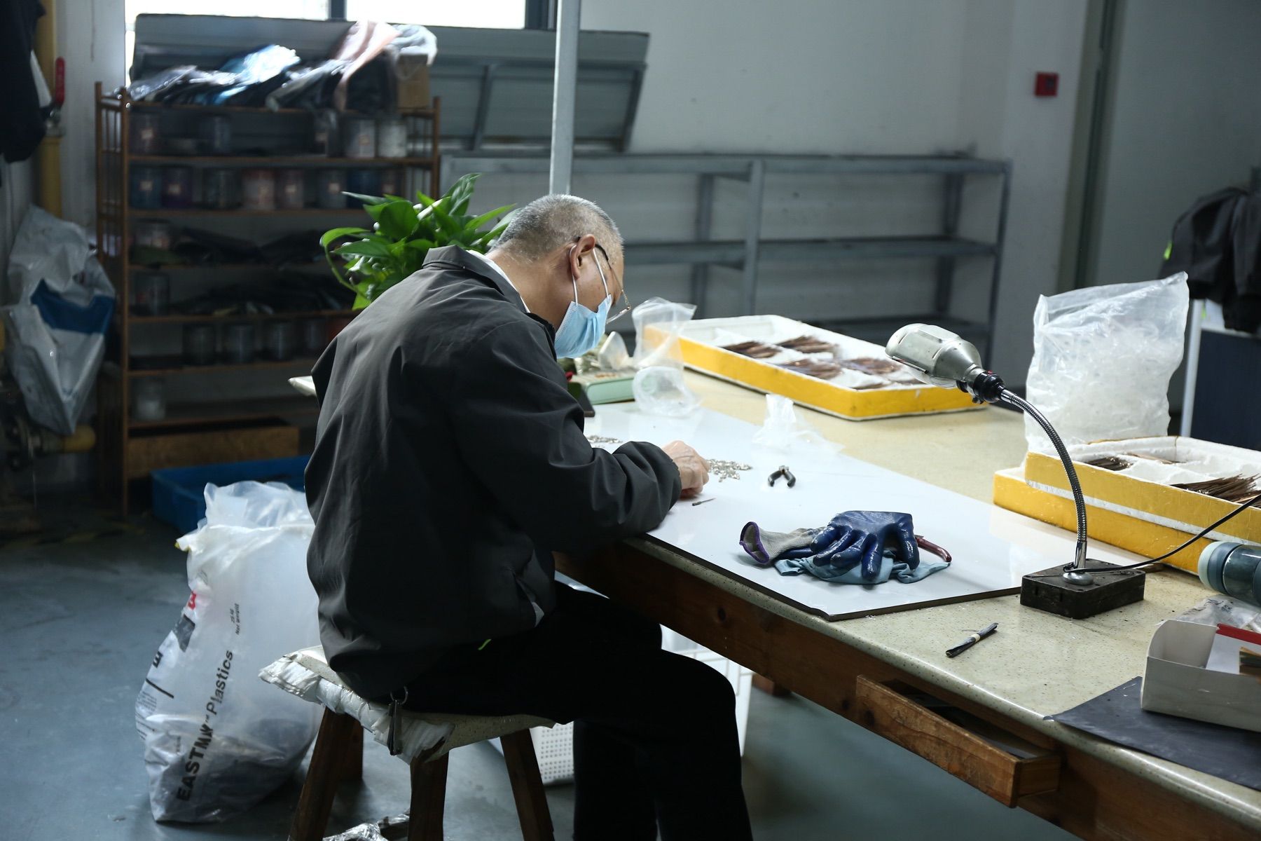 DOMI eyewear technician preparing eyewear components