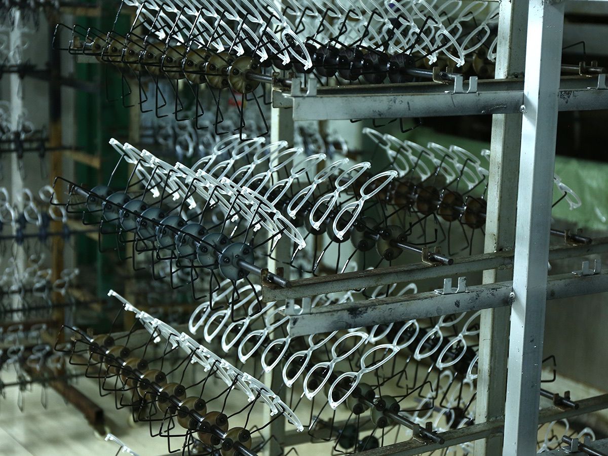 Eyewear frames arranged on production racks in the workshop