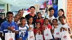 Group of young children holding Lifebuoy bags at an event to launch the brand in East Timor.