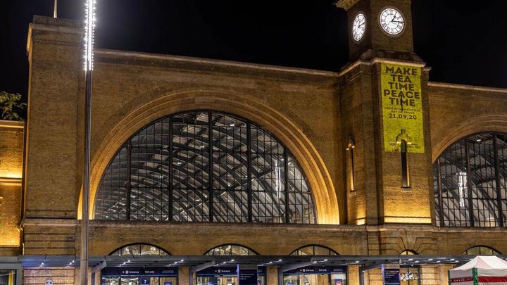 ipton illuminated the clock tower at King's Cross Station in London, UK with the message: 'Make tea time peace time'.