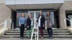 Four female scientists who work with Polycultural Centre of Excellence, standing in front of the building 
