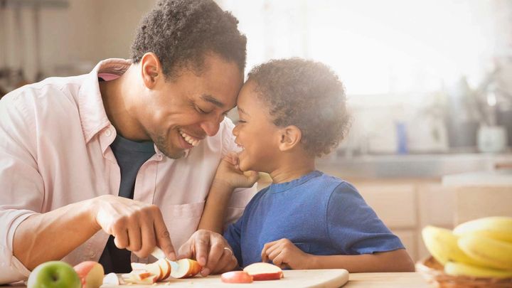 Father and child chopping fruit