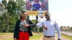 Unilever East Africa’s Home Care Director and Absa’s Director of Business Banking standing in front of a Sunlight billboard.