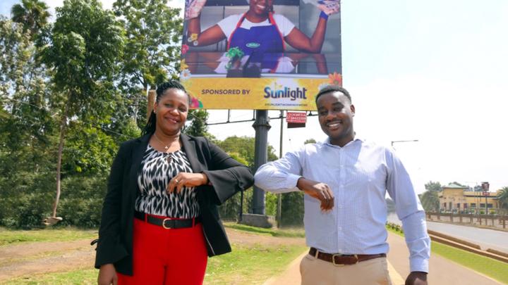 Unilever East Africa’s Home Care Director and Absa’s Director of Business Banking standing in front of a Sunlight billboard.