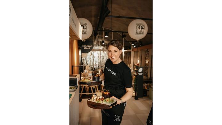 A waitress serving food from The Vegetarian Butcher at a pop-up event in the Netherlands.
