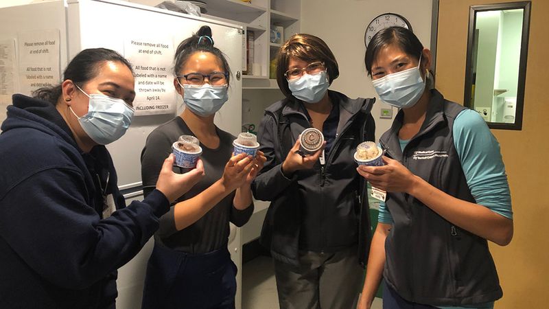 Four women holding out tubs of ice cream – part of Ben & Jerry’s Project Joy