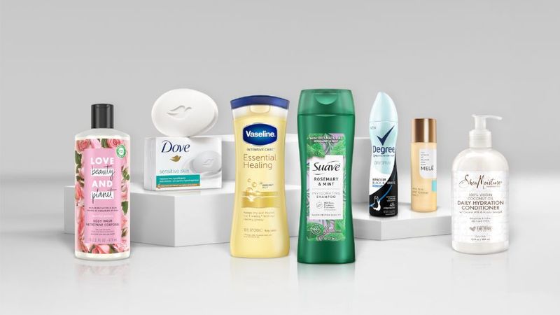 An assortment of Unilever brand products, including Dove soap, Love Beauty and Planet bodywash, and Suave shampoo.