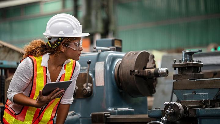 Factory worker assessing material