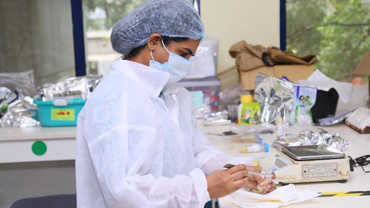 Image of a female HUL scientist working on testing a powder in a laboratory