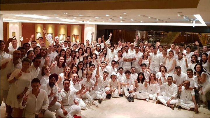 About 50 people from Unilever International team pose for a group photo in an event space