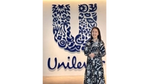 Kristine Go poses in front of a big Unilever logo mounted on a wall