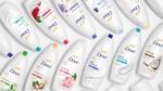 A collection of different Dove body wash products lying on a white background. 