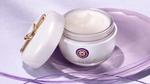 A pot of Tatcha Silk Cream with the lid removed and propped against the open pot.