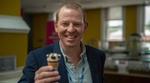 Matt Close, President of Unilever’s Ice Cream business group, smiling and holding a cornetto ice cream towards the camera