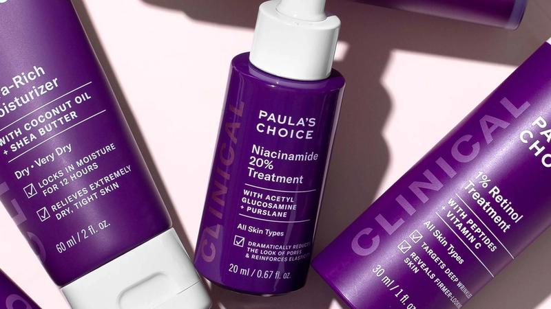 An array of Paula’s Choice clinical skincare products in purple bottles with white lids.