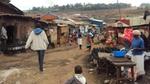Street scene in the Mukuru slum, showing humble dwellings with roofs of corrugated iron