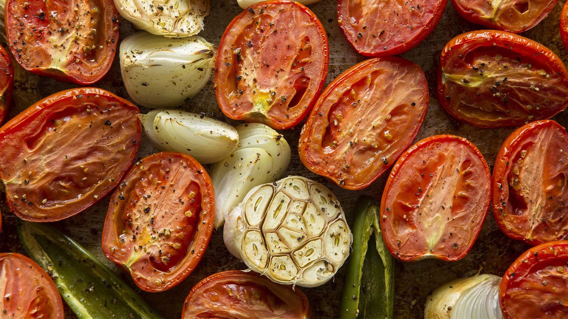 Tomatoes and Onions being cooked on a grill pan