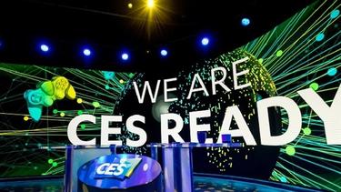 Floor of Consumer Electronics Show 2023 in Las Vegas, with banner image with words ‘We are CES ready’