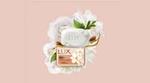 A pack of LUX Velvet soap surrounded by white jasmine flowers on a peach coloured background.
