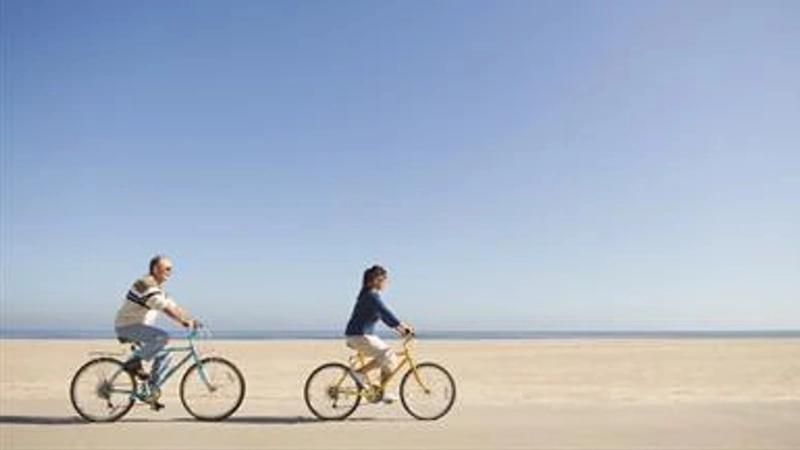 People cycling across a beach