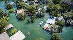 aerial view of flooded village in remote location with trees