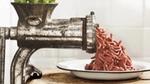 Meat grinder: vegetarian minced meat coming out of a metal meat-grinder