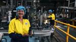 Unilever employee holding can of Lynx deodorant in factory