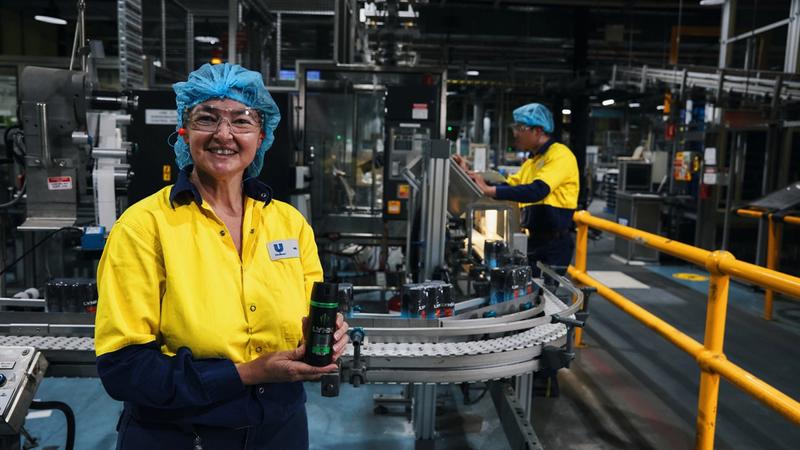 Unilever employee holding can of Lynx deodorant in factory