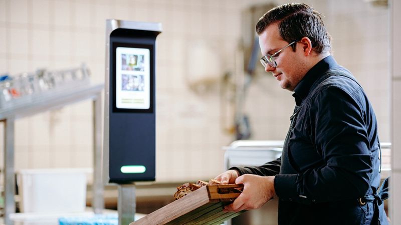 Man controlling food waste with technology