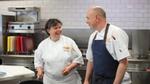UFS chef Audrey Crone laughing with another chef while cooking in a professional kitchen