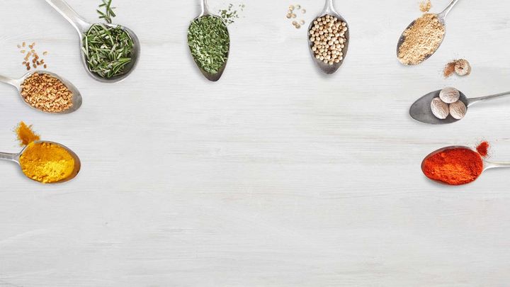 A collection of spoons in a semi-circle each containing a different ingredient