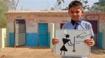 Boy with a poster showing how to unblock a toilet standing near a public toilet block 