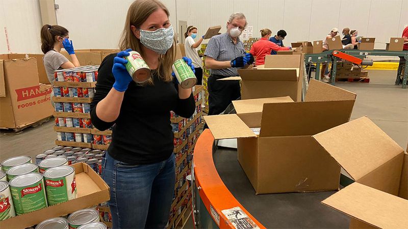 A photo of Unilever employees packing boxes for the United for America initiative