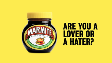 A jar of marmite against a yellow background, with text to the side saying 'are you a lover of a hater?