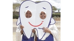 Girls holding a tooth costume in Kenya