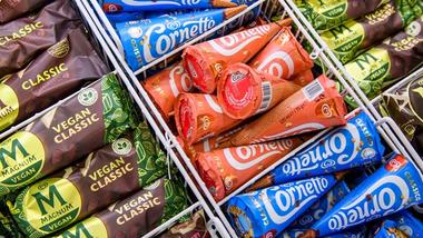 Overhead view of various Magnum and Cornetto ice creams in a freezer cabinet.