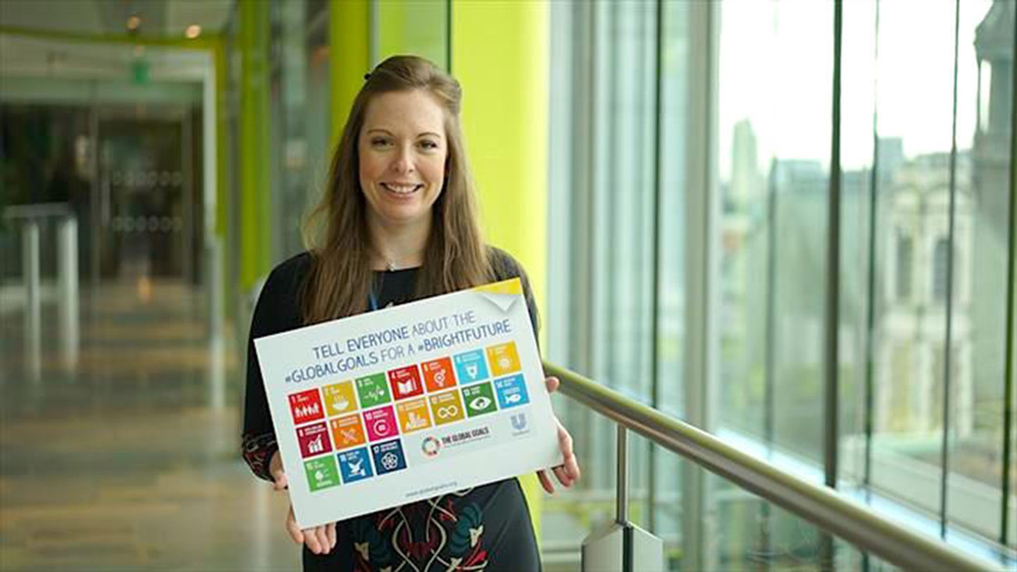 Woman holding a Global Goals sign