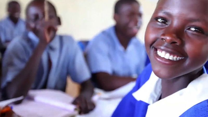 A girl smilling in a classroom