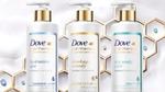 Advertising image showing four bottles in the new Dove Hair Therapy range.