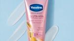 A pink tube of Vaseline “Gluta-Hya” cream against a light blue background.