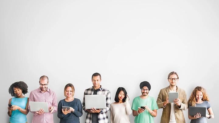 People in a row holding their devices
