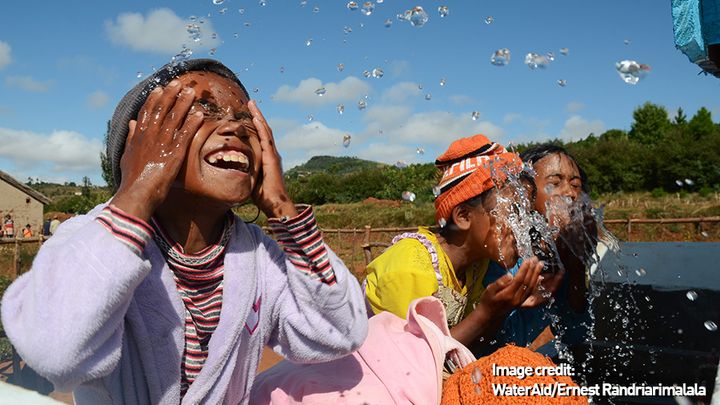 Children splashing water on their faces