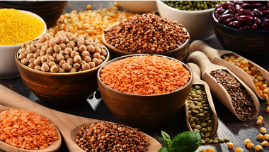 Assorted pulses and grains in bowls and spoons