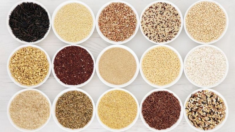 Small white bowls with a variety of grains including quinoa, wild rice, farro, amaranth, etc