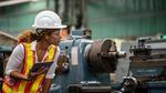 Factory worker assessing material