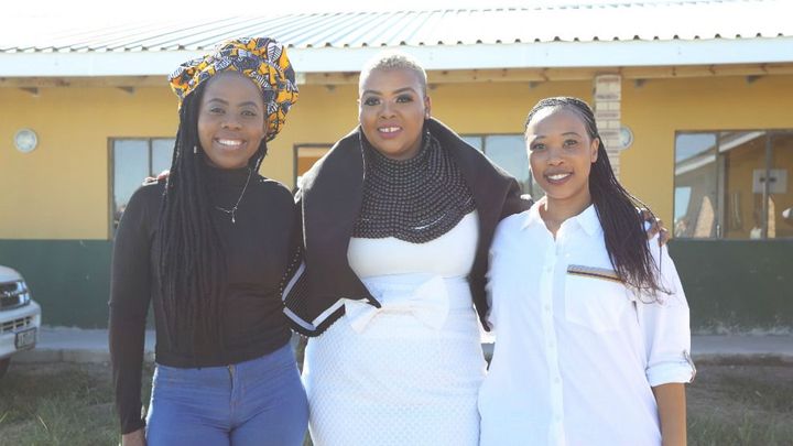 Three African women smiling