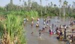 Villagers in Magadgascar using river for drinking water and domestic use
