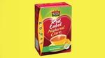 A box of Brooke Bond Red Label Natural Care tea against a yellow background. 