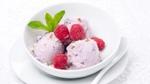 Dish of ice cream with raspberries