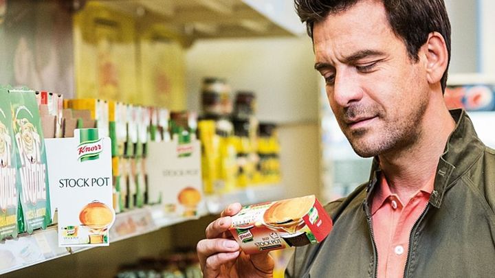 A man looking at the nutrition label on a Knorr product